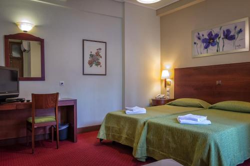 Кровать или кровати в номере City Hotel Apollonion