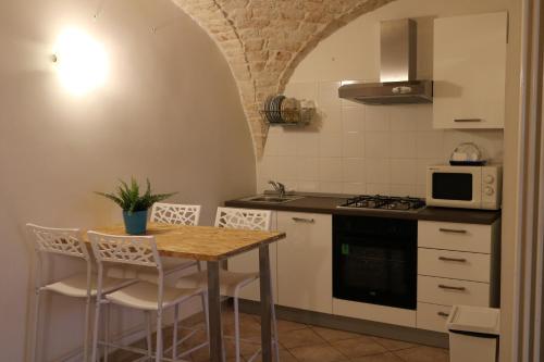 a kitchen with a table and chairs in a room at casa claudia in Putignano