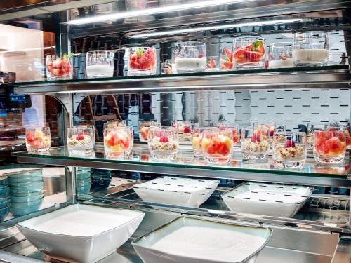 a kitchen with several dishes of food on display at STAGE 12 Hotel by Penz in Innsbruck