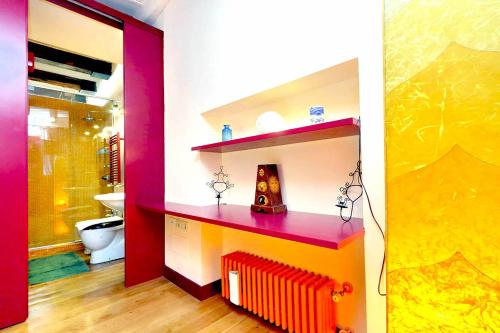 a bathroom with a red radiator and a toilet at delCINQUE 26 - Loft in Trastevere in Rome