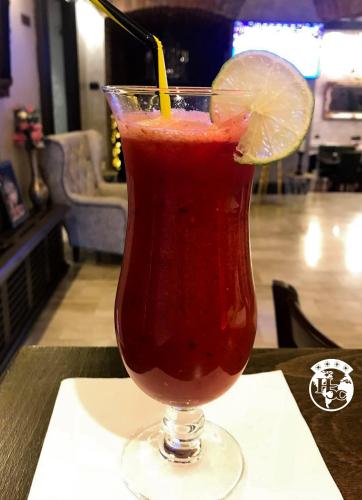 a drink in a glass with a lemon slice on a table at Hotel 5 Continents in Craiova