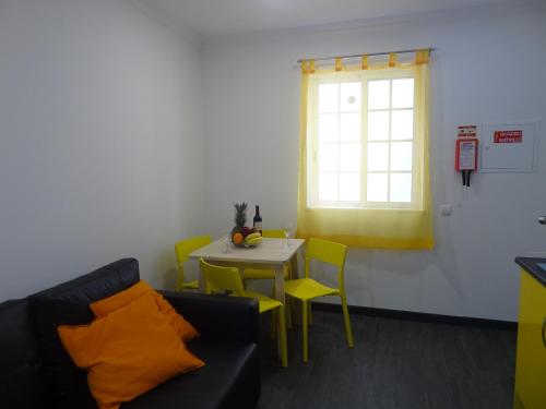 a living room with a couch and a table and a window at Fisherman's Palace in Olhão