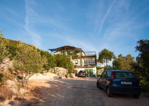 a blue car parked in front of a house at Bellavista Peljesac Peninsula in Dubrava