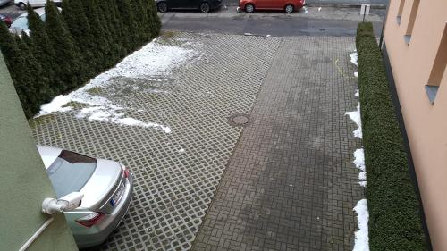 a driveway with a car parked in a parking lot at Penzion PIANO & Apartment Sokolov in Sokolov