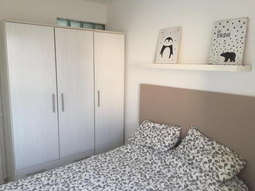 a bedroom with a bed and white cabinets at Sol y mar in Arinaga