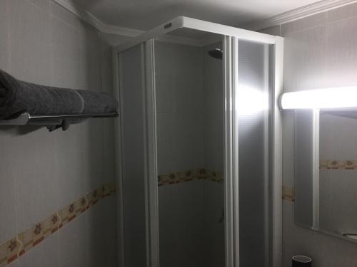 a shower with a glass door in a bathroom at Sol y mar in Arinaga