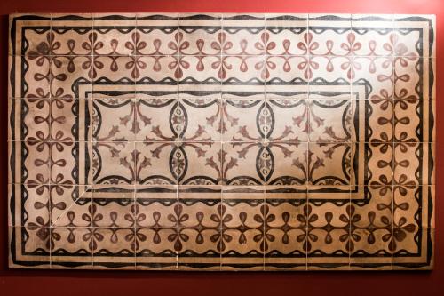 a tile wall with a pattern on it at Ad Hoc Rooms in Palermo