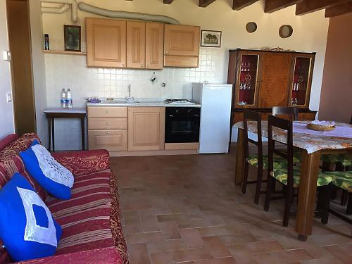 a kitchen with a couch and a kitchen with a table at Agriturismo Prato Grande in Loiano