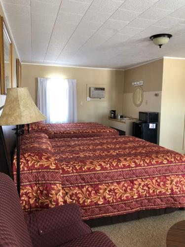 a hotel room with a bed and a window at Dunlop Motel in Goderich