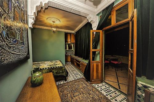 a room with a kitchen and a room with a table at Riad Scalia Traditional Guesthouse Fes Morocco in Fès