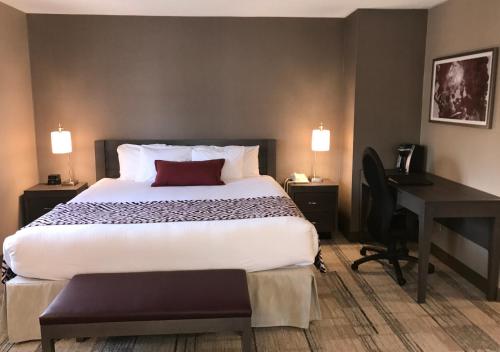 a hotel room with a large bed and a desk at Best Western Colonel Butler Inn in Niagara on the Lake