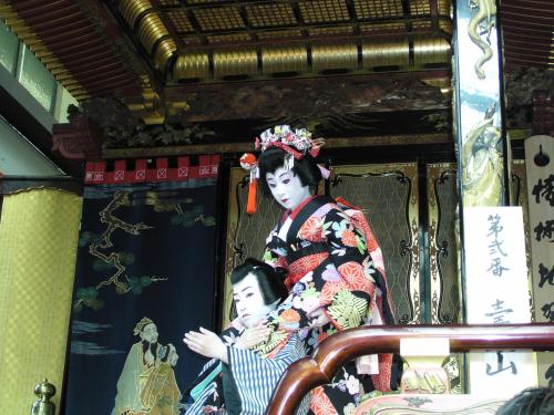 a statue of a woman and a child in a room at Kitabiwako Hotel Grazie in Nagahama