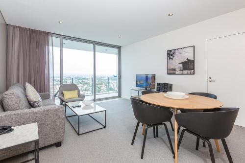 a living room with a table and a couch at Wyndham Resort Surfers Paradise in Gold Coast