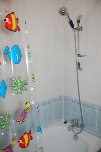 a shower curtain with fishes on it in a bathroom at Sanatoriy Zhosaly in Qarqaraly