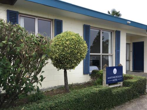 a house with a sign in front of it at Martinborough Motel in Martinborough 