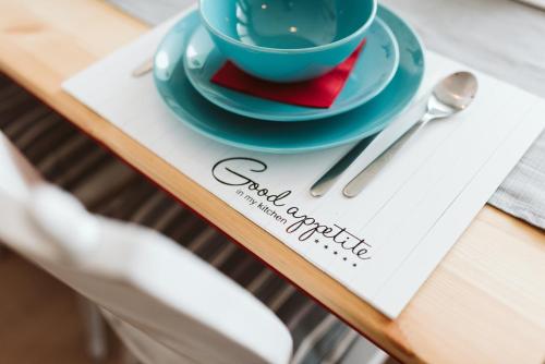 a book with a cup of coffee on a table at MOOKI Beach Apartment in Bodensdorf