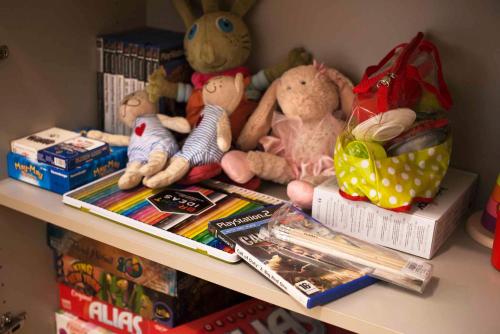 a shelf with stuffed animals and books on it at Family Apartment in Tallinn