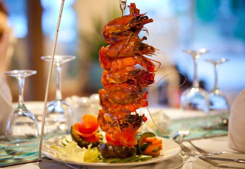 a dish of food on a plate on a table at Turtle Bay Beach Club- All Inclusive in Watamu