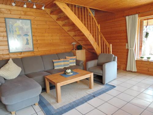 a living room with a couch and a table at ****FH Blauvogel 60 Harz in Hasselfelde