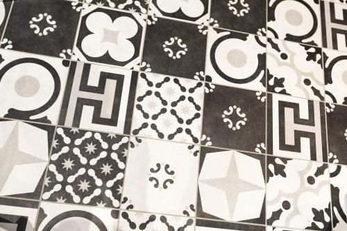 a black and white tile floor with white and black at Le 1615 - Luxe et Spa in Colmar