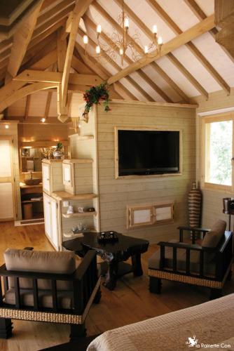 a living room with a flat screen tv on the wall at Cabane d'Amour in Béziers