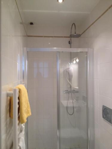a bathroom with a shower with a glass door at Lyo Hôtel - Centre Lyon Perrache in Lyon