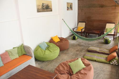 a living room with couches and a hammock at Lion's Rest in Weligama