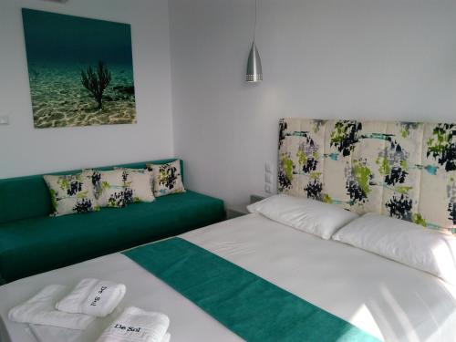 a small bedroom with a bed and a couch at De Sol in Limenaria