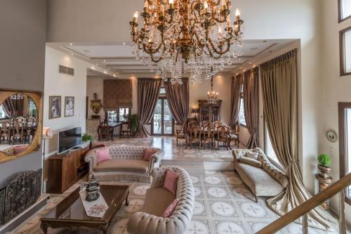 a large living room with a chandelier at Eva's Luxury Villa in Kritharia