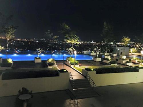 a view of a swimming pool at night at Evo Bangi Duplex Homestay D' Imahzzz - 3BR or 2BR in Bangi