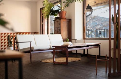 a living room with a white couch and a table at Casa Boumort in Sant Marti de Canals