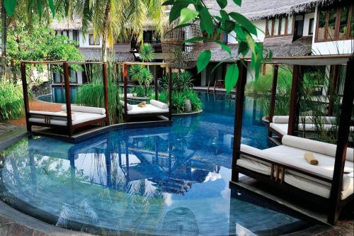a large swimming pool with two chairs in a building at Villa Samadhi by Samadhi Age 12 and Above Only in Kuala Lumpur