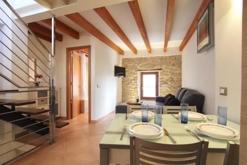 a kitchen and living room with a table and chairs at Eu Forat in Pollença