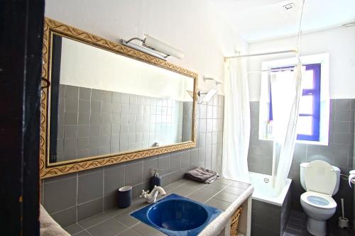 a bathroom with a blue sink and a mirror at La Lleona Apartment in Girona