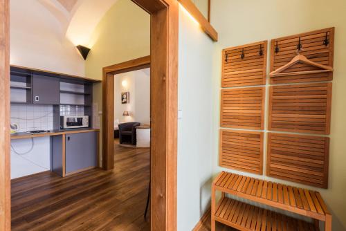 a room with a wooden door and a kitchen and a room at HolidayPark Mlázovy in Kolinec