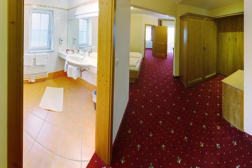 a large bathroom with a sink and a toilet at Ferienhotel Innviertel in Kirchheim im Innkreis