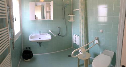 a bathroom with a sink and a shower and a toilet at Hotel Casa Diomira in Lido di Camaiore