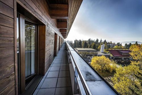 a balcony with a view of a building at Crocus Apartments 310, 507 in Štrbské Pleso