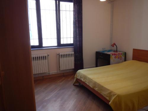 a bedroom with a bed and a large window at Spacious apartment in Aygedzor street in Yerevan