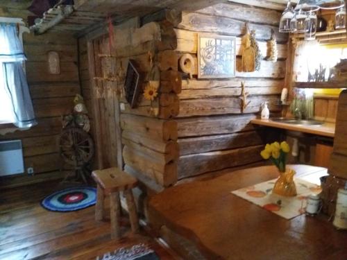 a room with a table in a wooden cabin at Agrousadba Nad Nemanom in Byarozawka