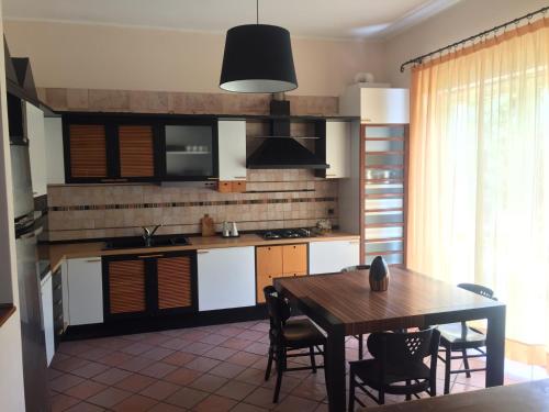 a kitchen with a table and a dining room at La Villa Del Cedro in Monza