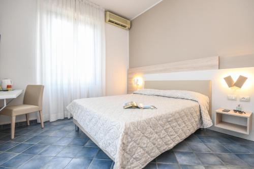 Postel nebo postele na pokoji v ubytování Hotel Riel