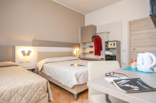 Postel nebo postele na pokoji v ubytování Hotel Riel