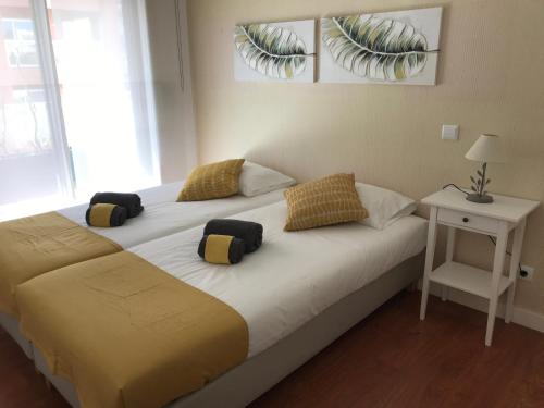 a bedroom with a bed with two pillows on it at Apartamento T&T Ocean - Foz Palace Residence Spa in Portimão
