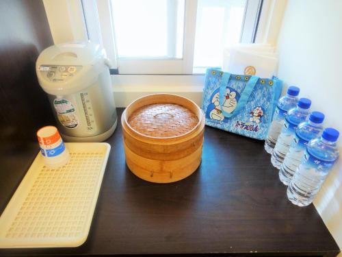 a counter with a bowl of food and bottles of water at Chin Shan B&B in Guanshan