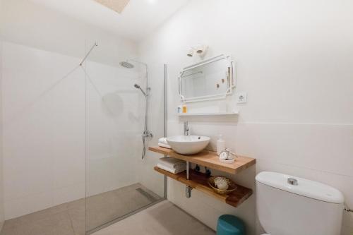 a bathroom with a toilet and a sink and a shower at Maresía Canteras Urban Hotel in Las Palmas de Gran Canaria