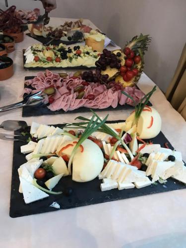 three plates of cheese and fruit on a table at Hotel Ski&Sky in Predeal