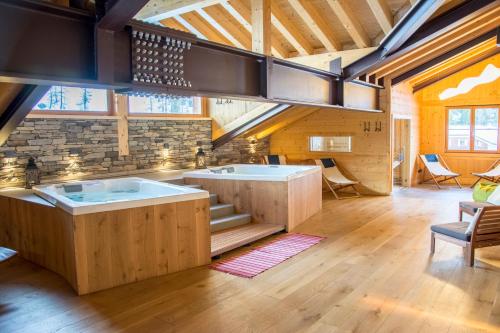 a large kitchen with two tubs in a room at Hotel Dufour in Gressoney-la-Trinité