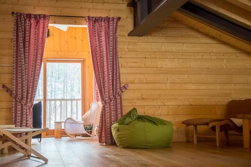 a room with wooden walls and a large window at Hotel Dufour in Gressoney-la-Trinité