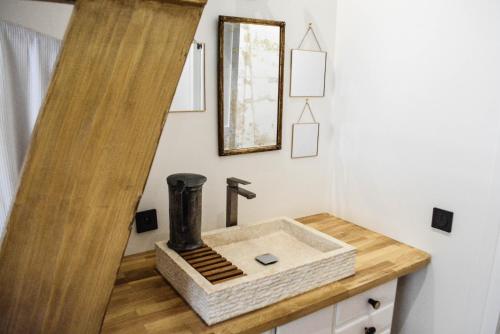 a bathroom with a sink and a mirror at Maison In Normandie in Saint-Pierre-la-Garenne